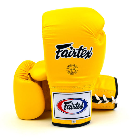 Yellow boxing gloves with Fairtex logo on a white background