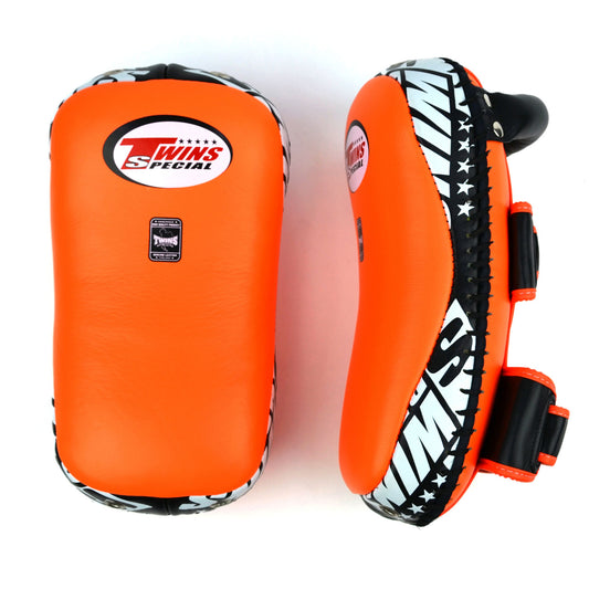 Orange kick pads with Twins Special logo on a white background