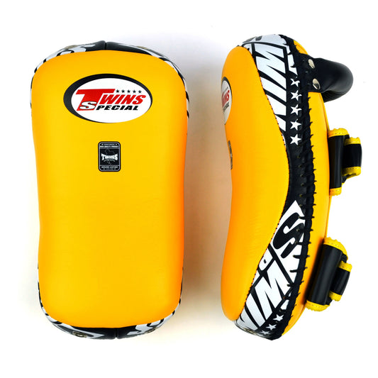 Yellow kick pads with Twins Special logo on a white background