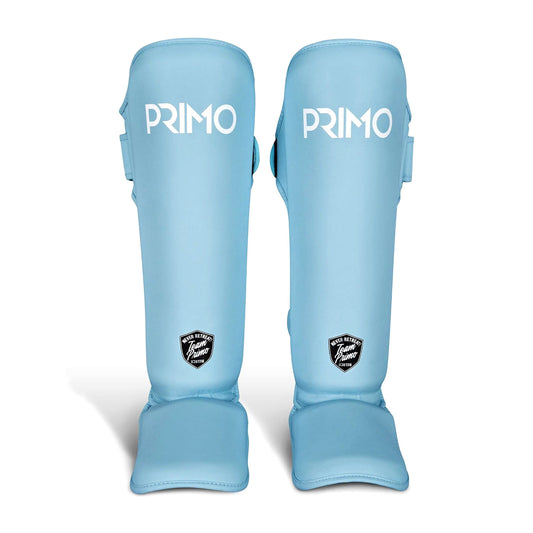 Pair of light blue shin guards with 'Primo' branding on a white background