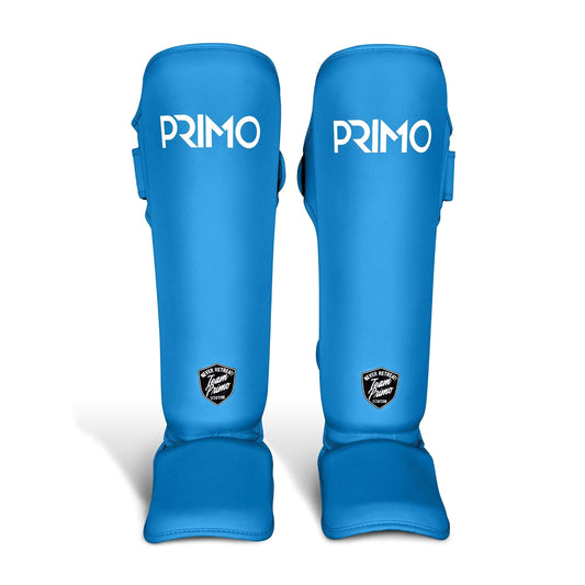 Pair of blue shin guards with 'Primo' branding on a light gray background