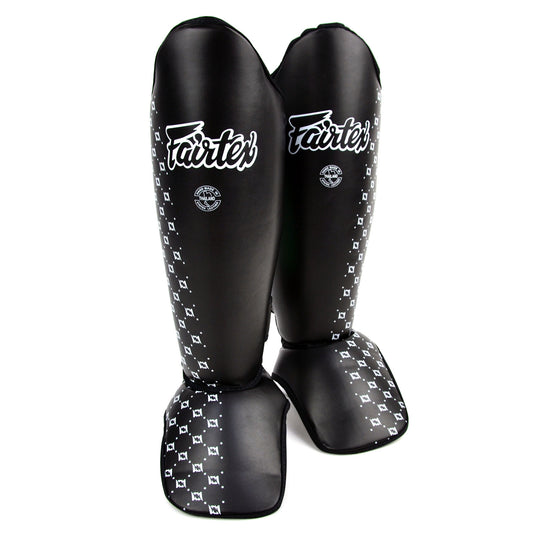 Black shin guards with white pattern and 'Fairtex' branding on a white background