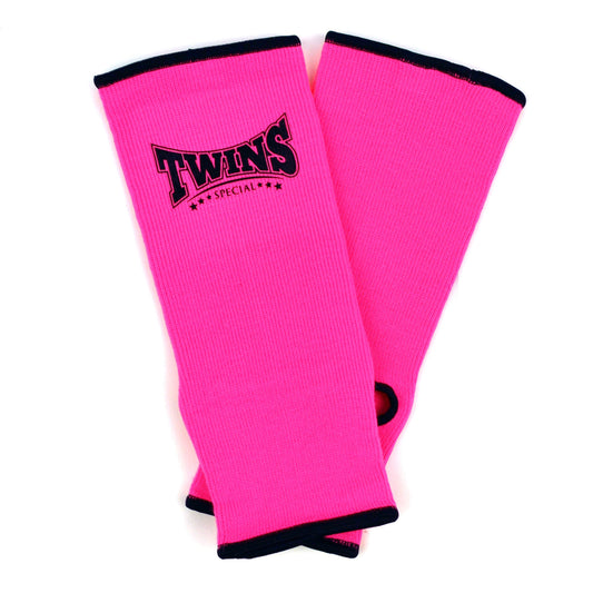 Pink ankle guards with 'Twins Special' logo on a white background