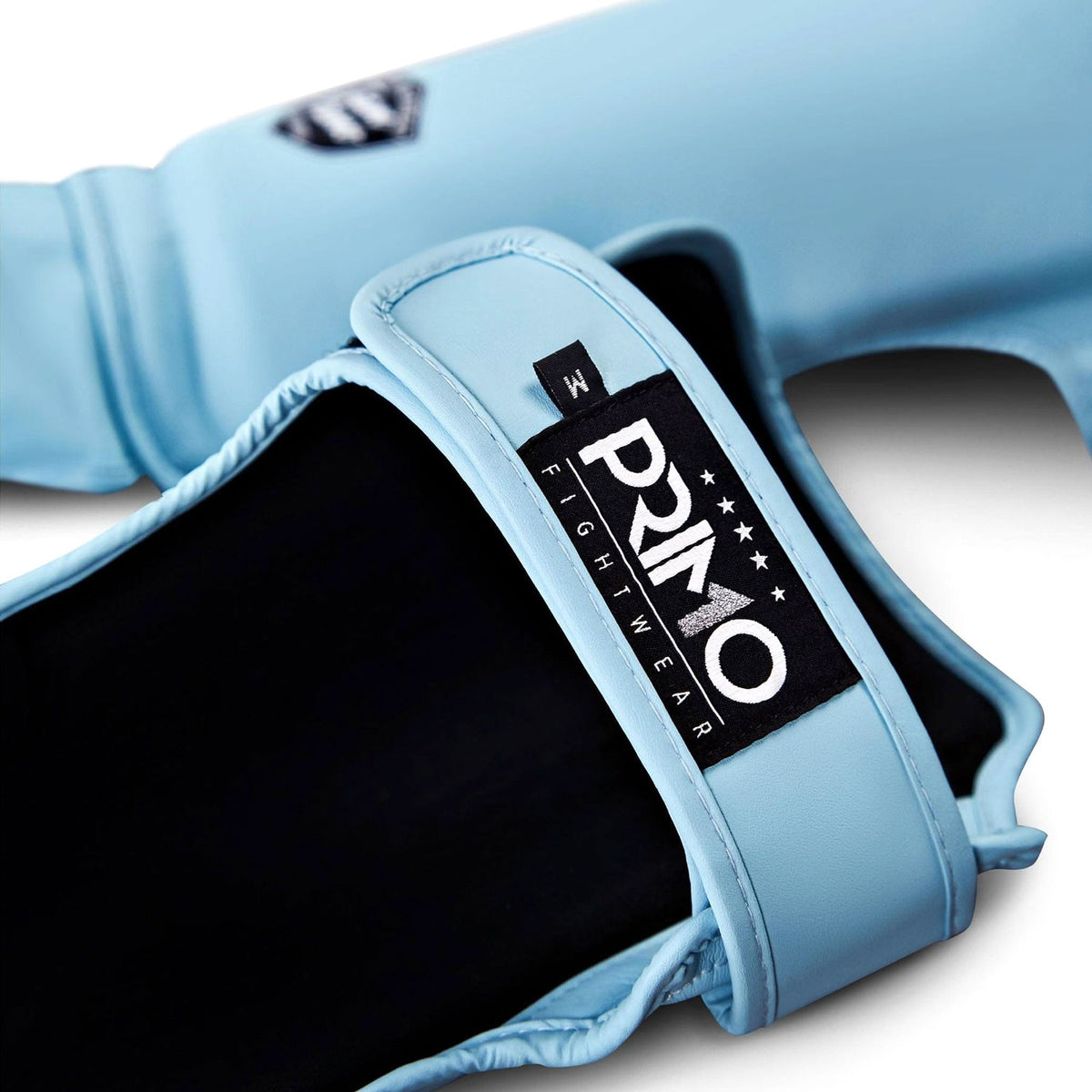 Light blue boxing glove with a Primo Fightwear label on a white background