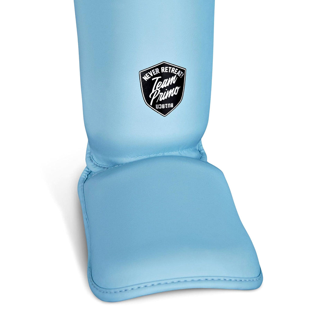 Light blue shin guard with a logo on a white background