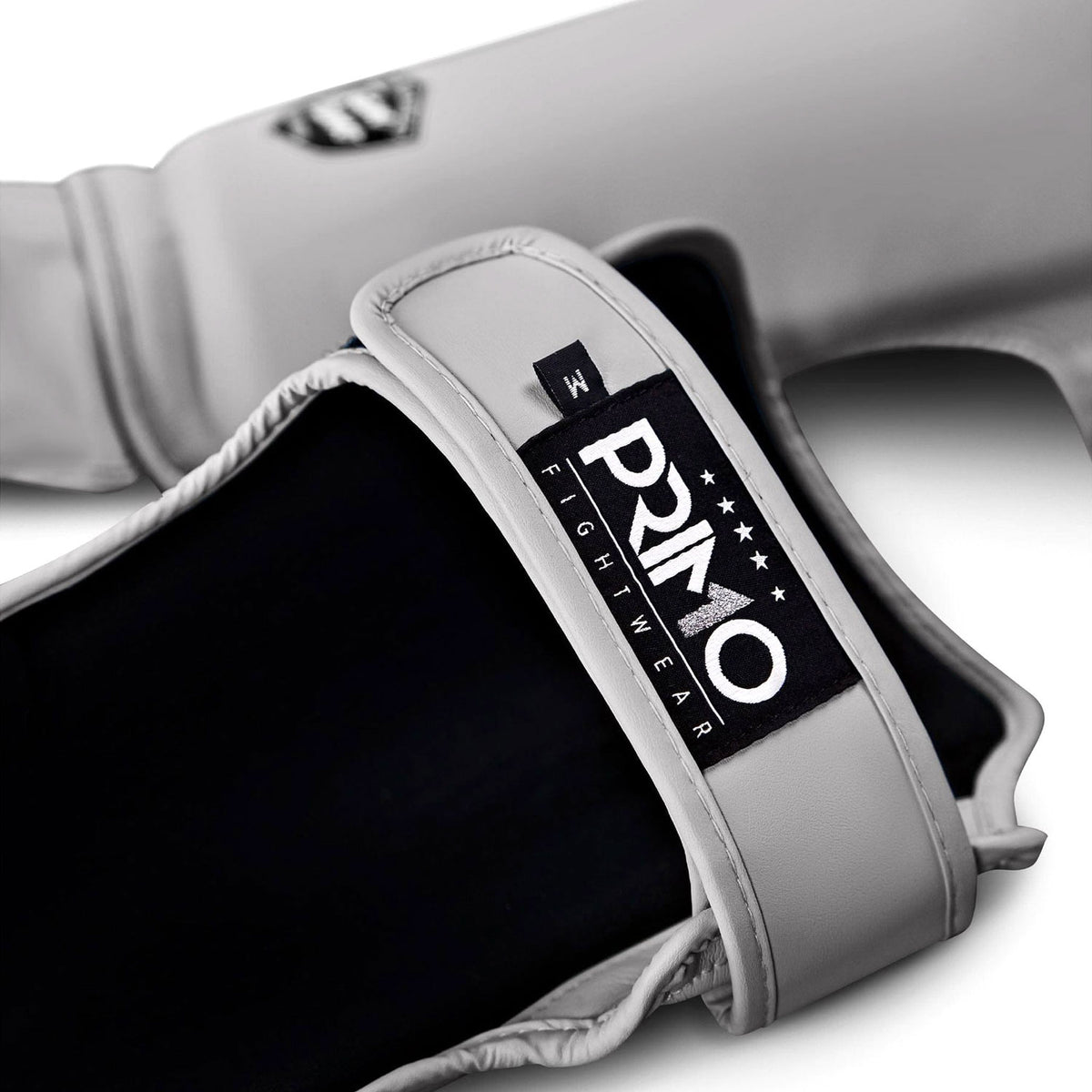 Gray boxing glove with a Primo Fight Wear logo on a white background
