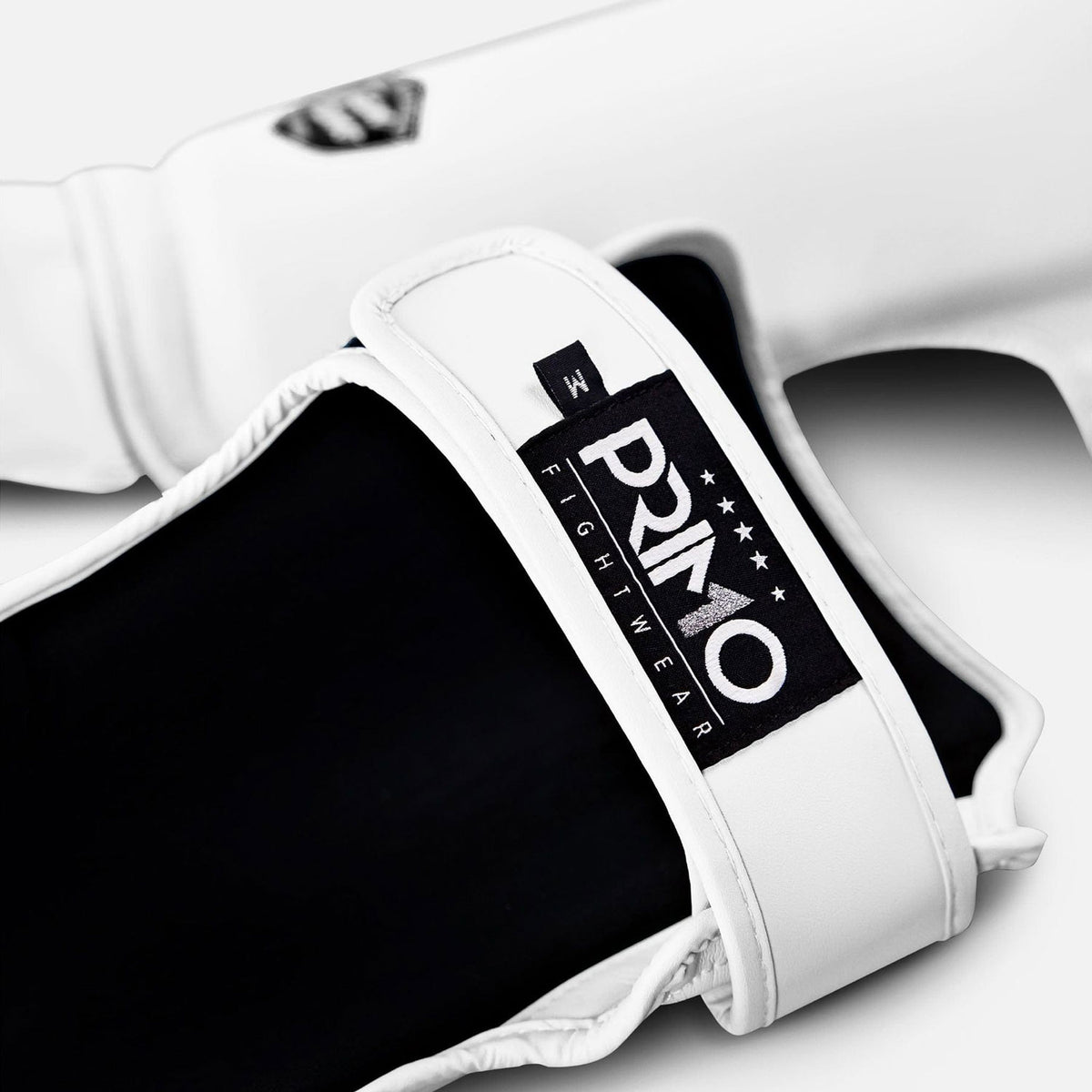 White boxing glove with black palm and Primo Fight Wear logo on a white background