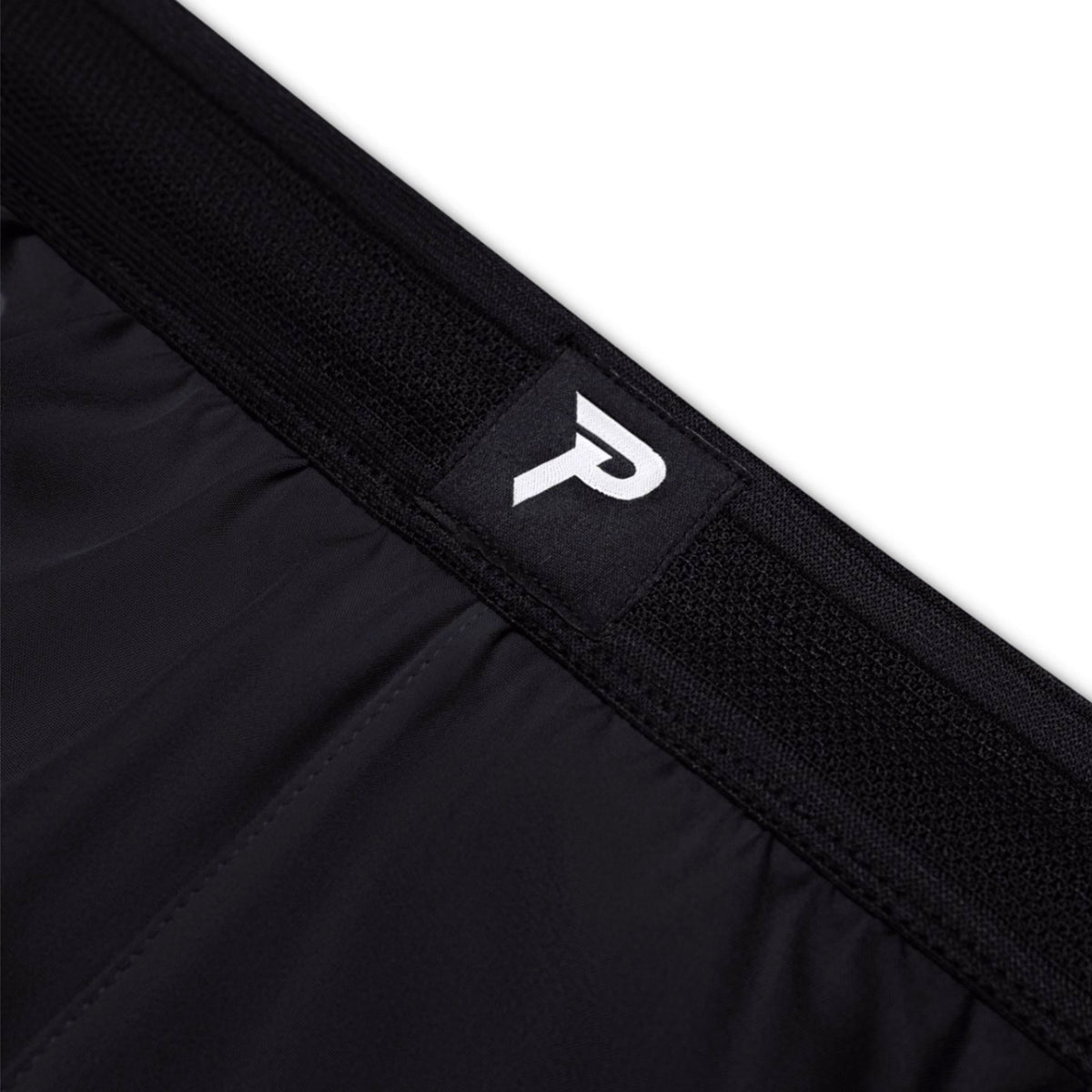 Black athletic shorts with a brand logo on a white background
