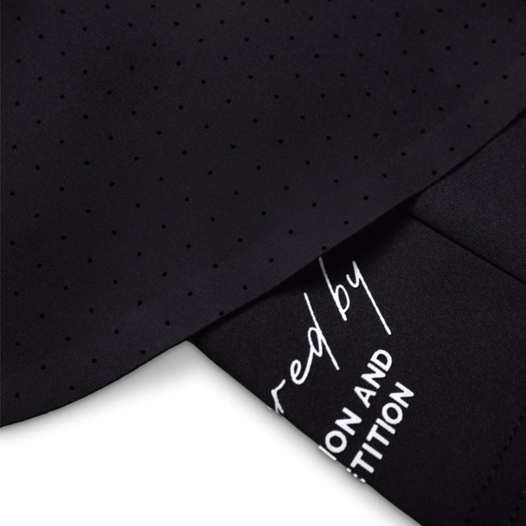Black textured fabric with a label on a white background