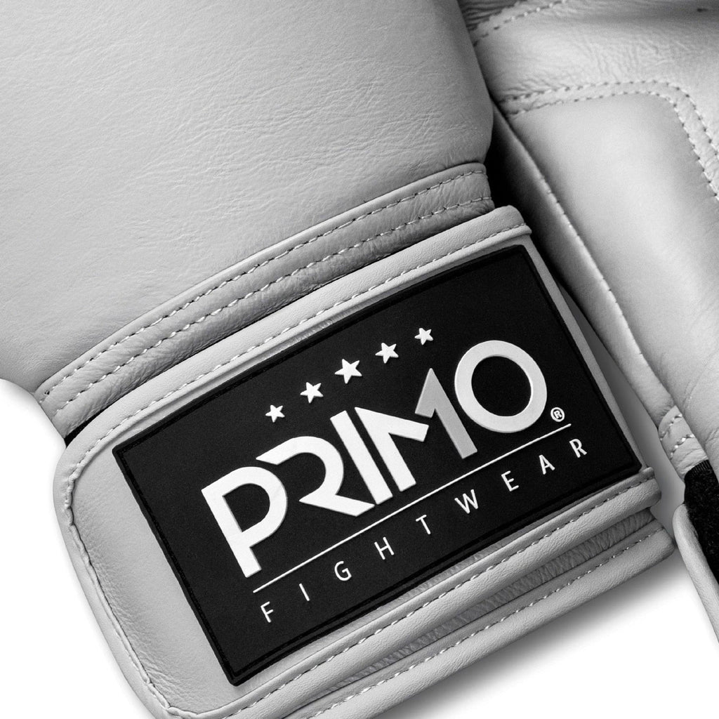 White boxing glove with Primo Fightwear logo on a light gray background