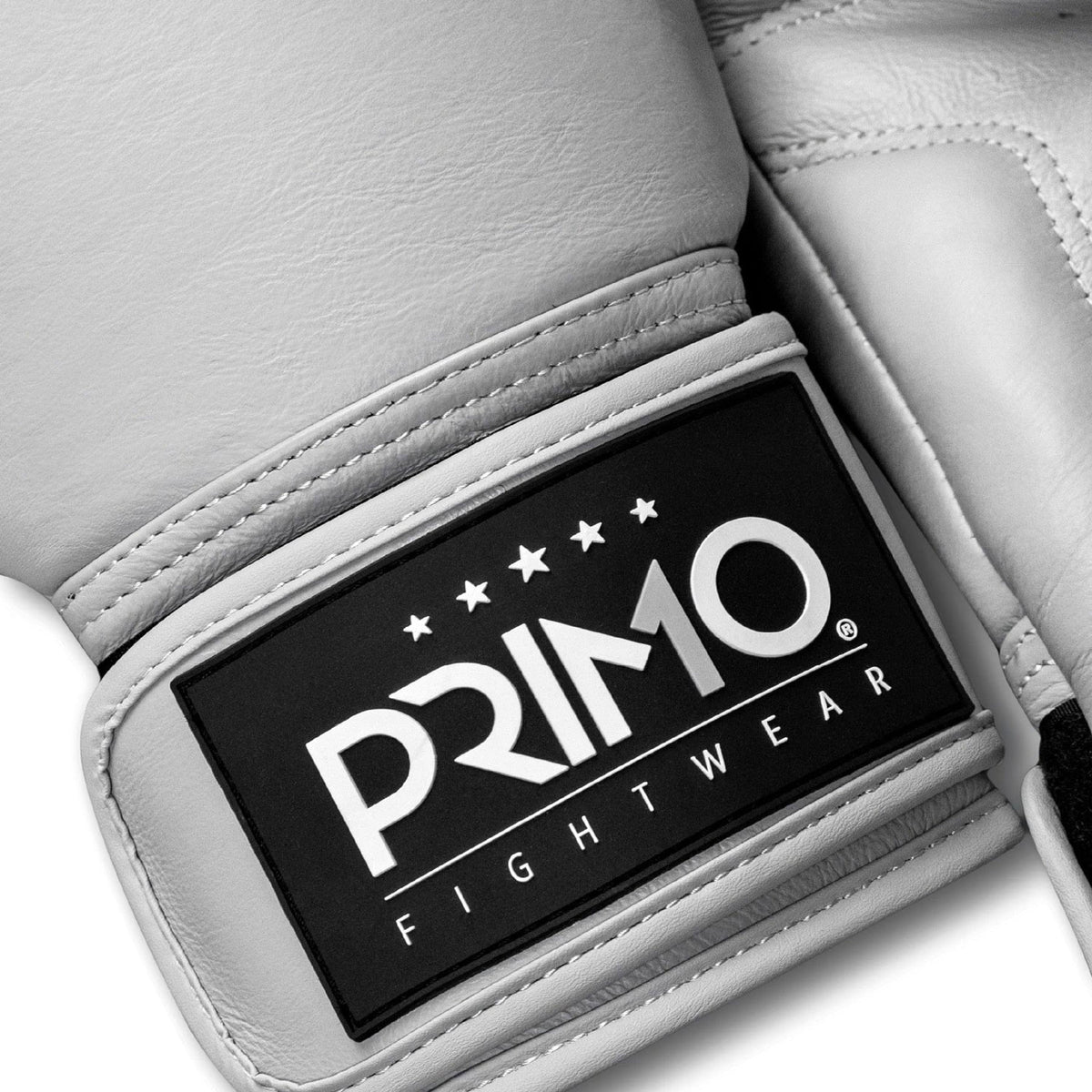 White boxing glove with Primo Fightwear logo on a light gray background