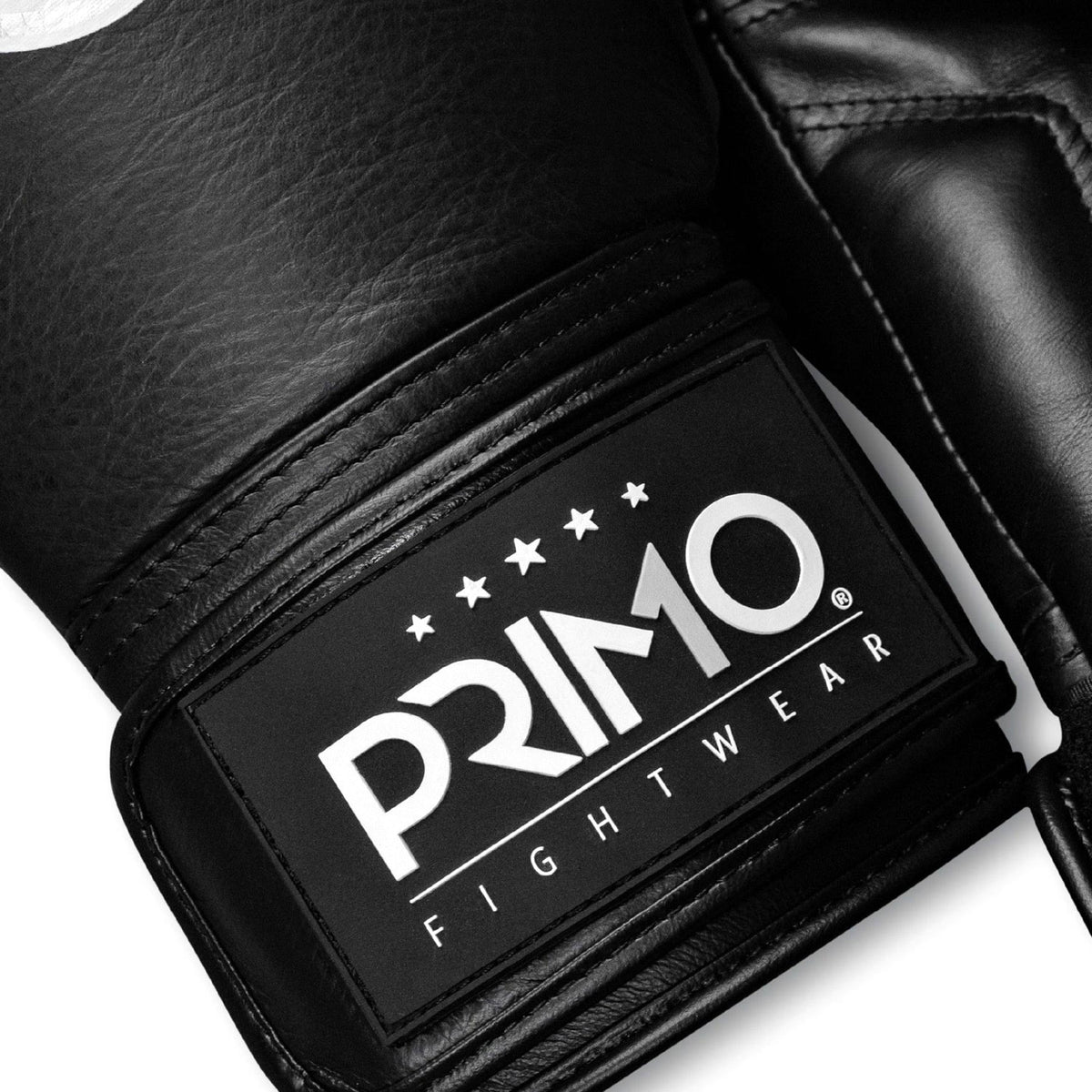 Black boxing glove with Primo Fightwear logo on a white background