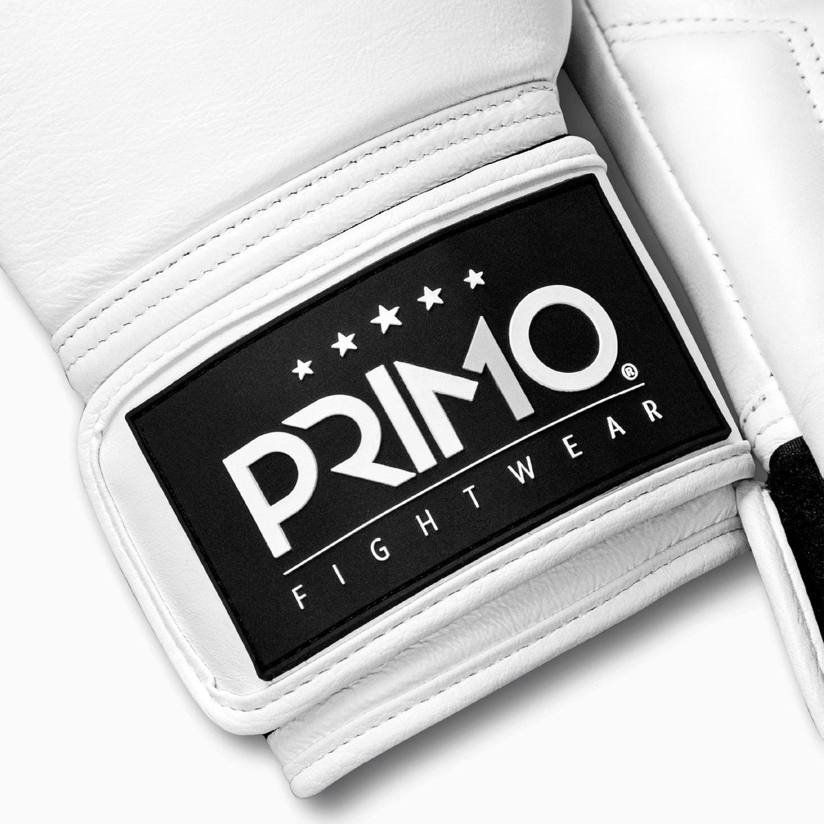 White boxing glove with Primo Fight Wear logo on a white background