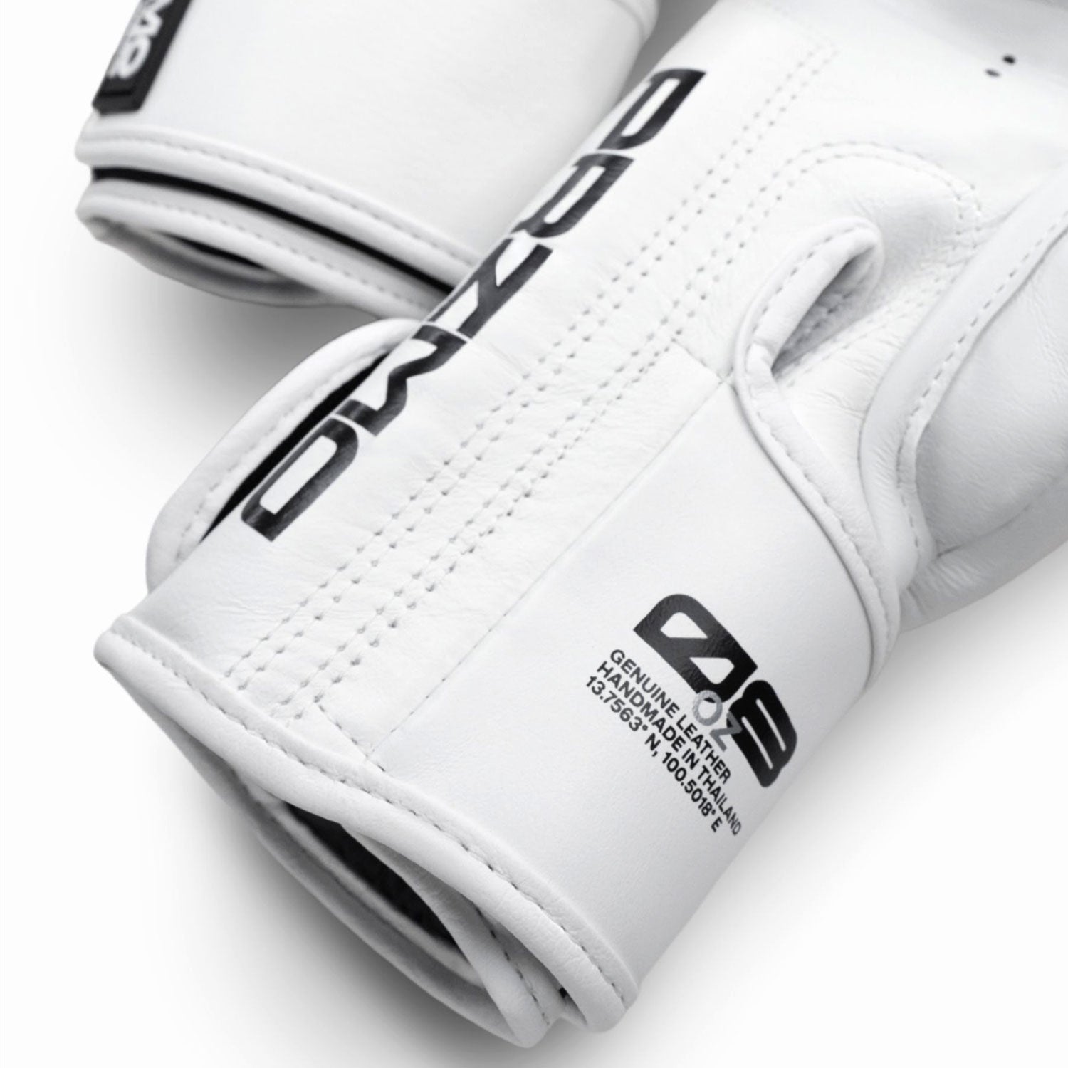 White gloves with black branding on a light gray background