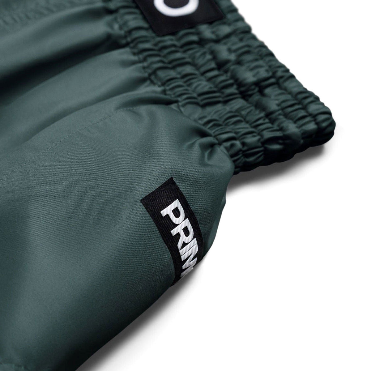 Green shorts with a visible brand logo on a white background