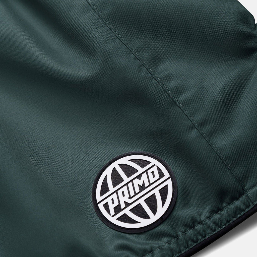 Close-up of a green jacket with a 'Primo' logo patch.