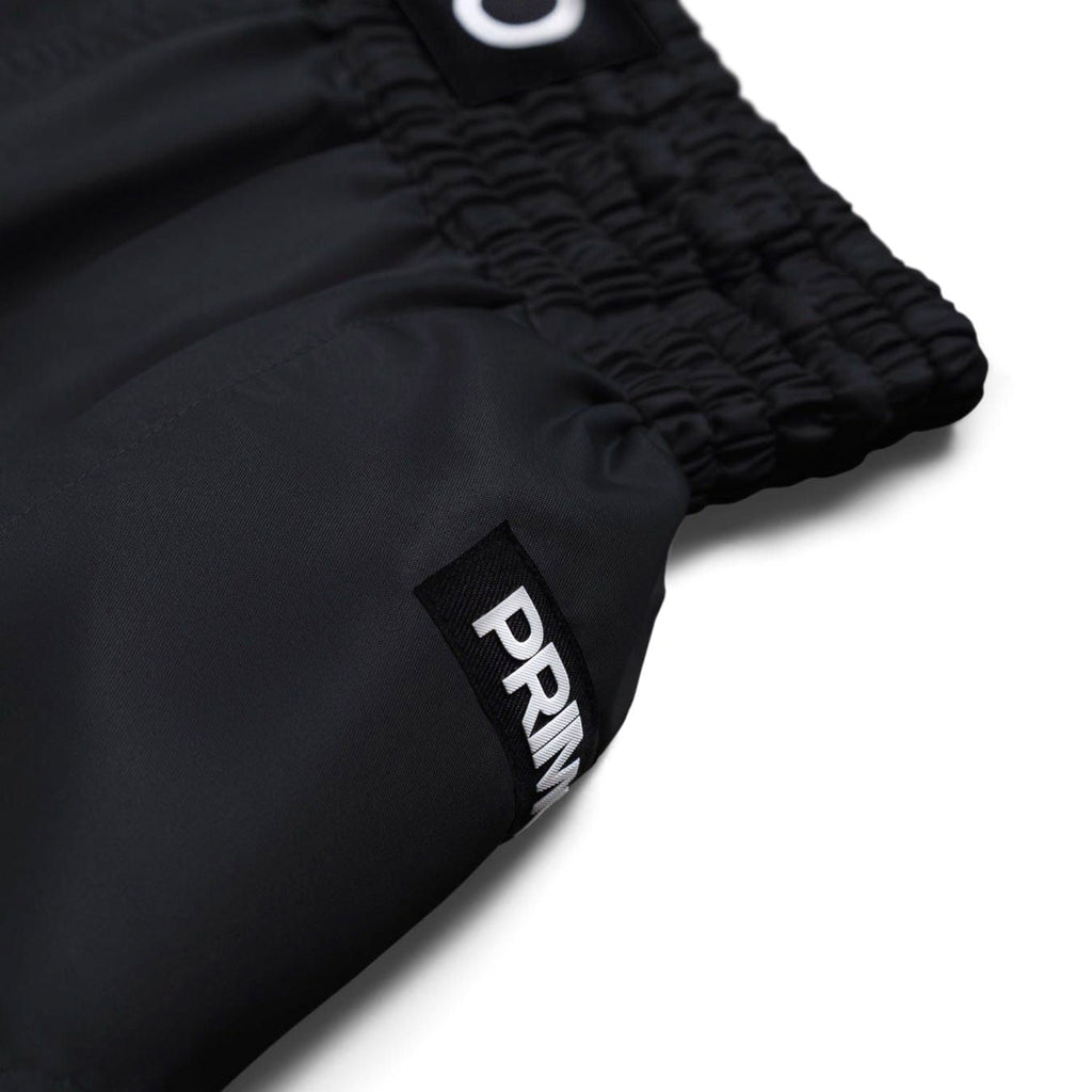 Black shorts with a visible brand logo on a white background