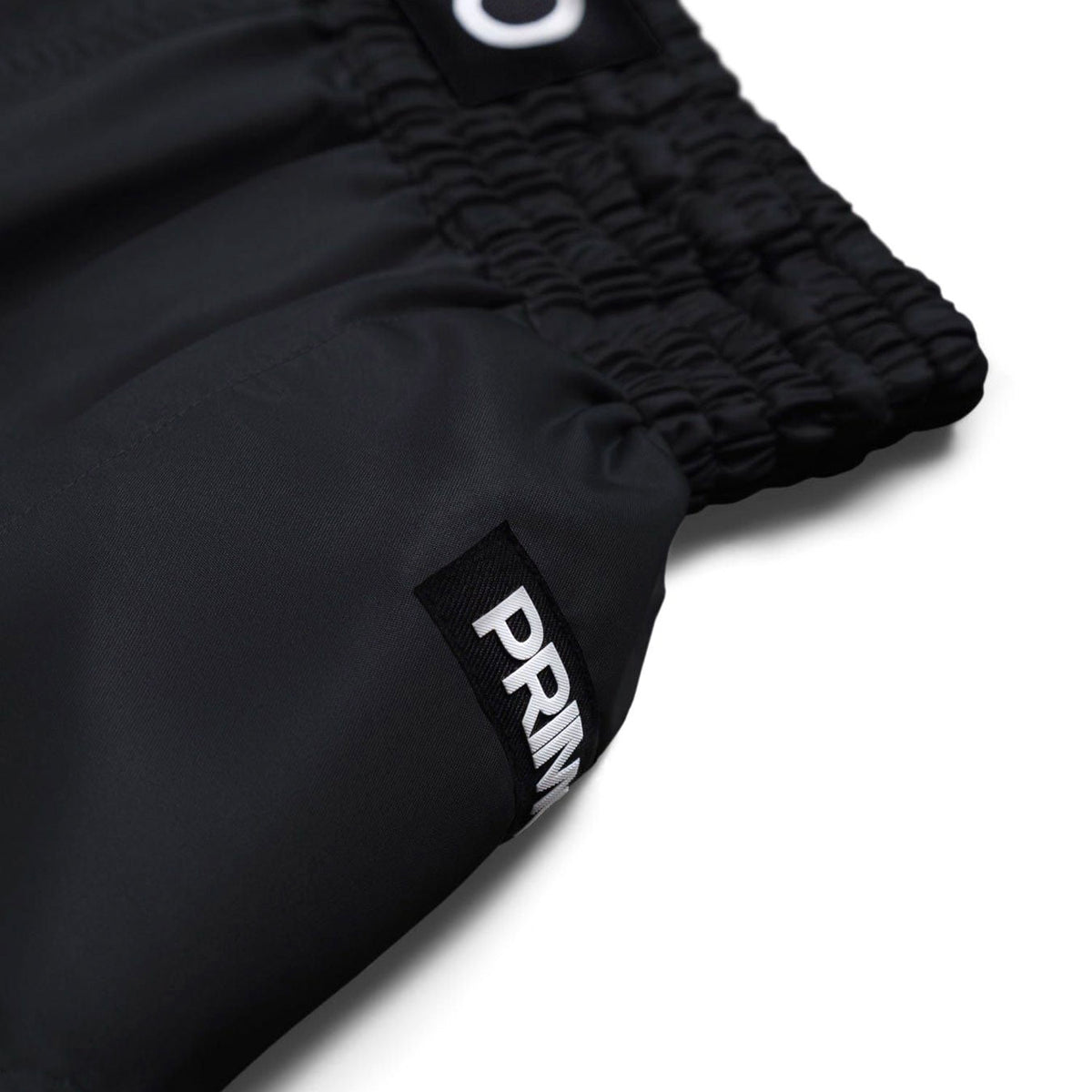 Black shorts with a visible brand logo on a white background