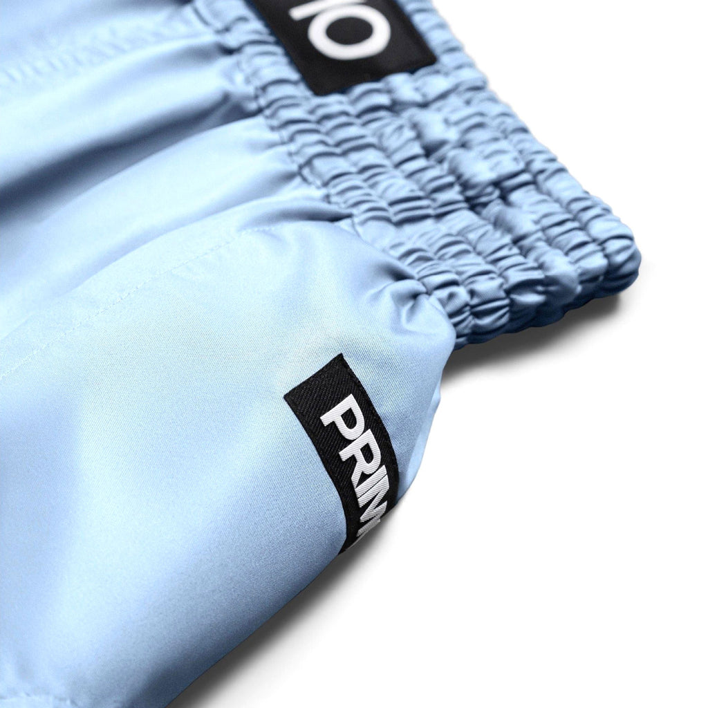 Light blue shorts with black labels on a white background