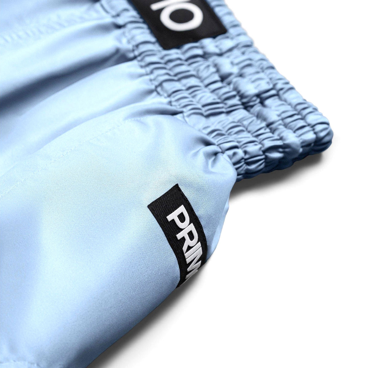 Light blue shorts with black labels on a white background