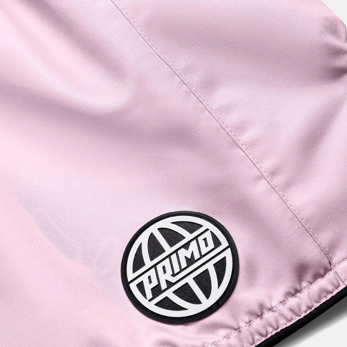 Close-up of a pink jacket with a Primo logo patch.