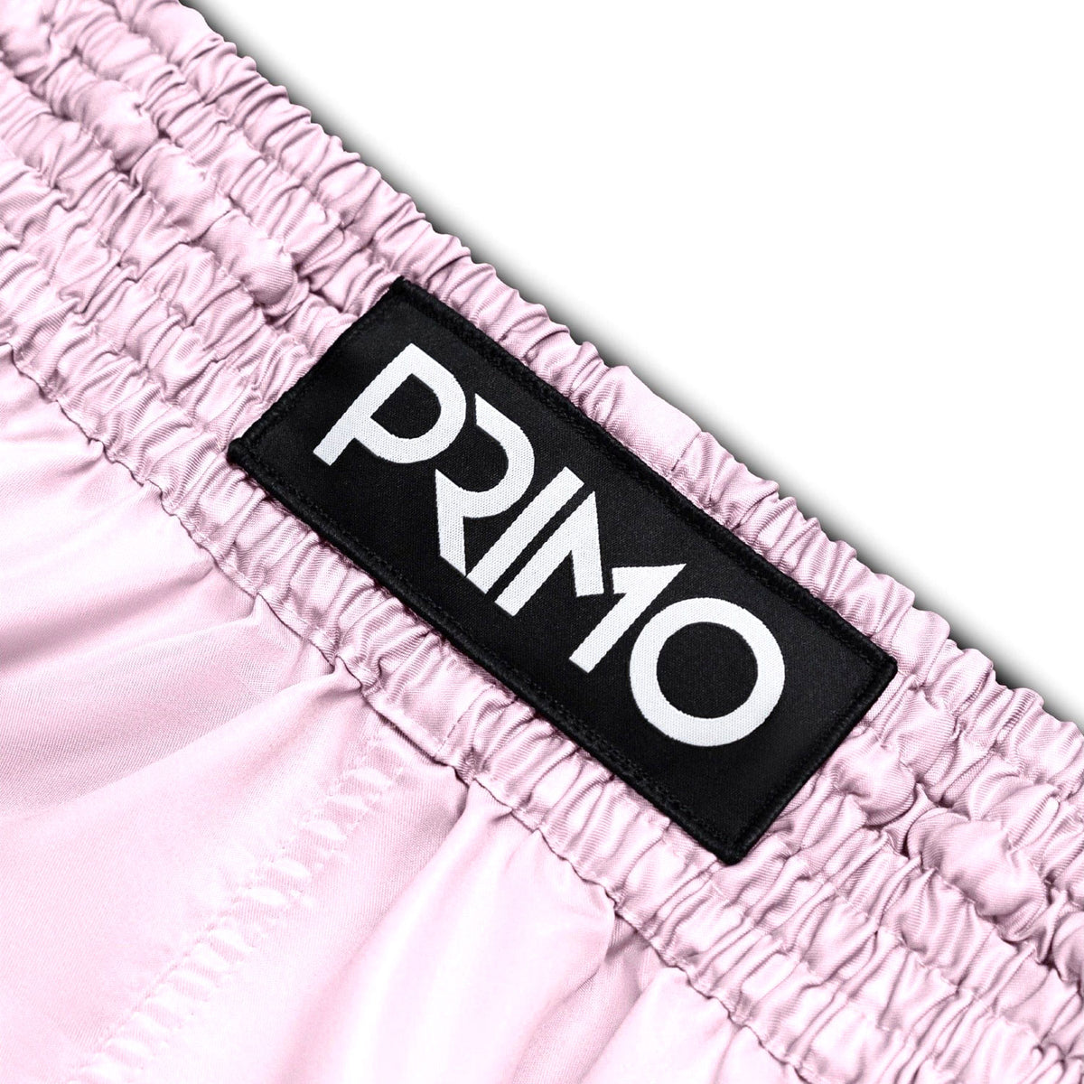 Close-up of pink fabric with a 'Primo' label on a white background