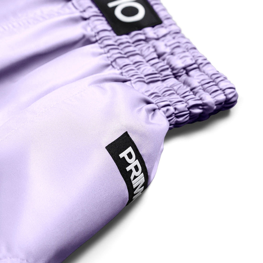 Purple shorts with brand logos on a white background