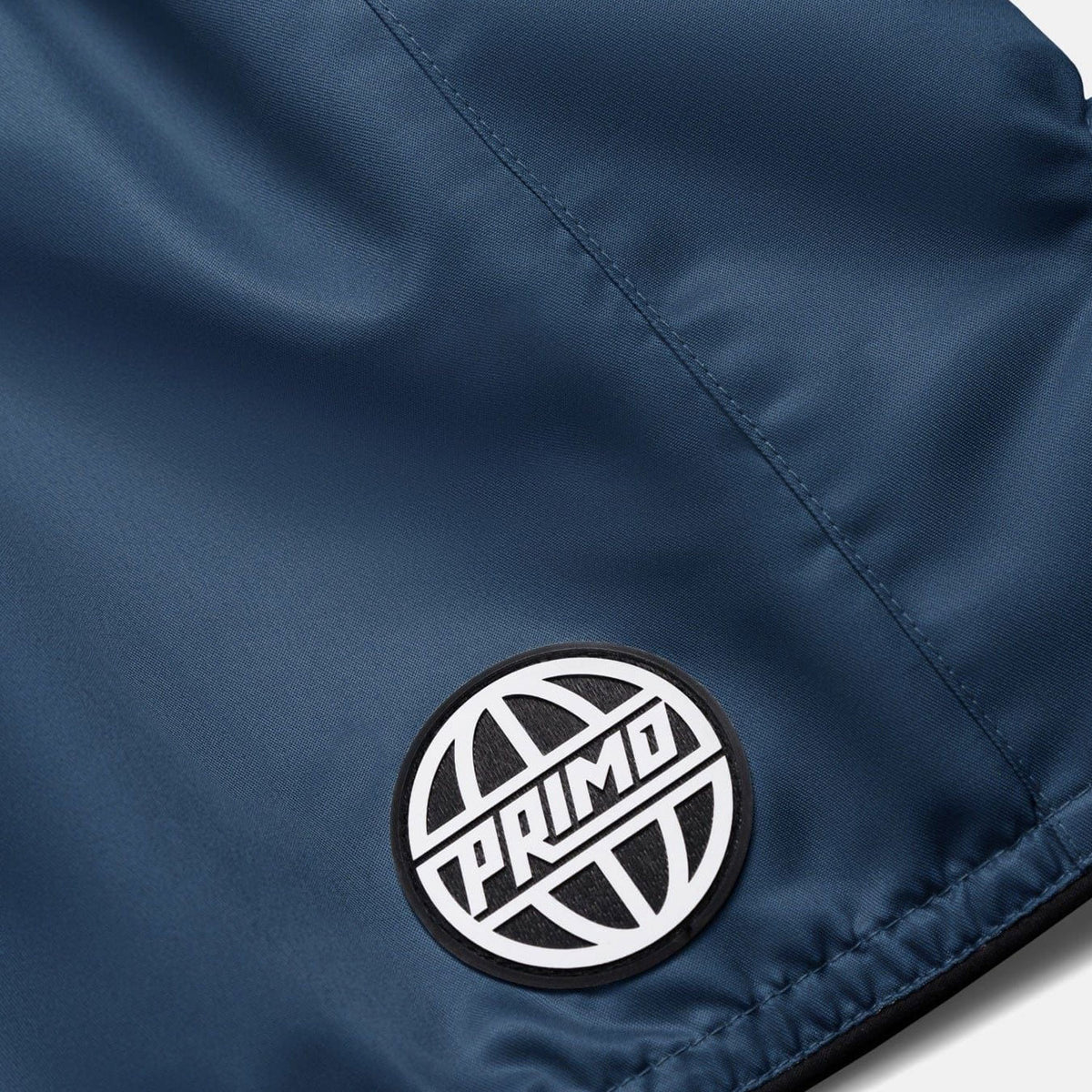 Close-up of a blue jacket with a 'Primo' logo patch.
