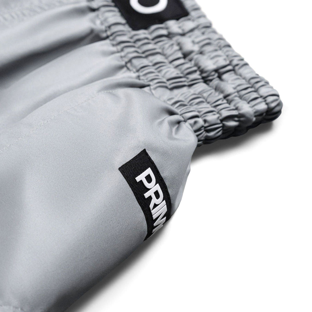 Gray shorts with a brand logo on a white background