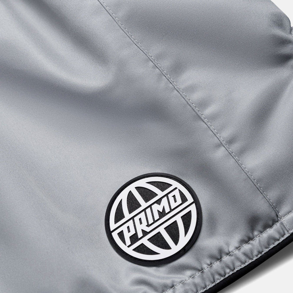 Close-up of a gray jacket with a Primo logo patch.