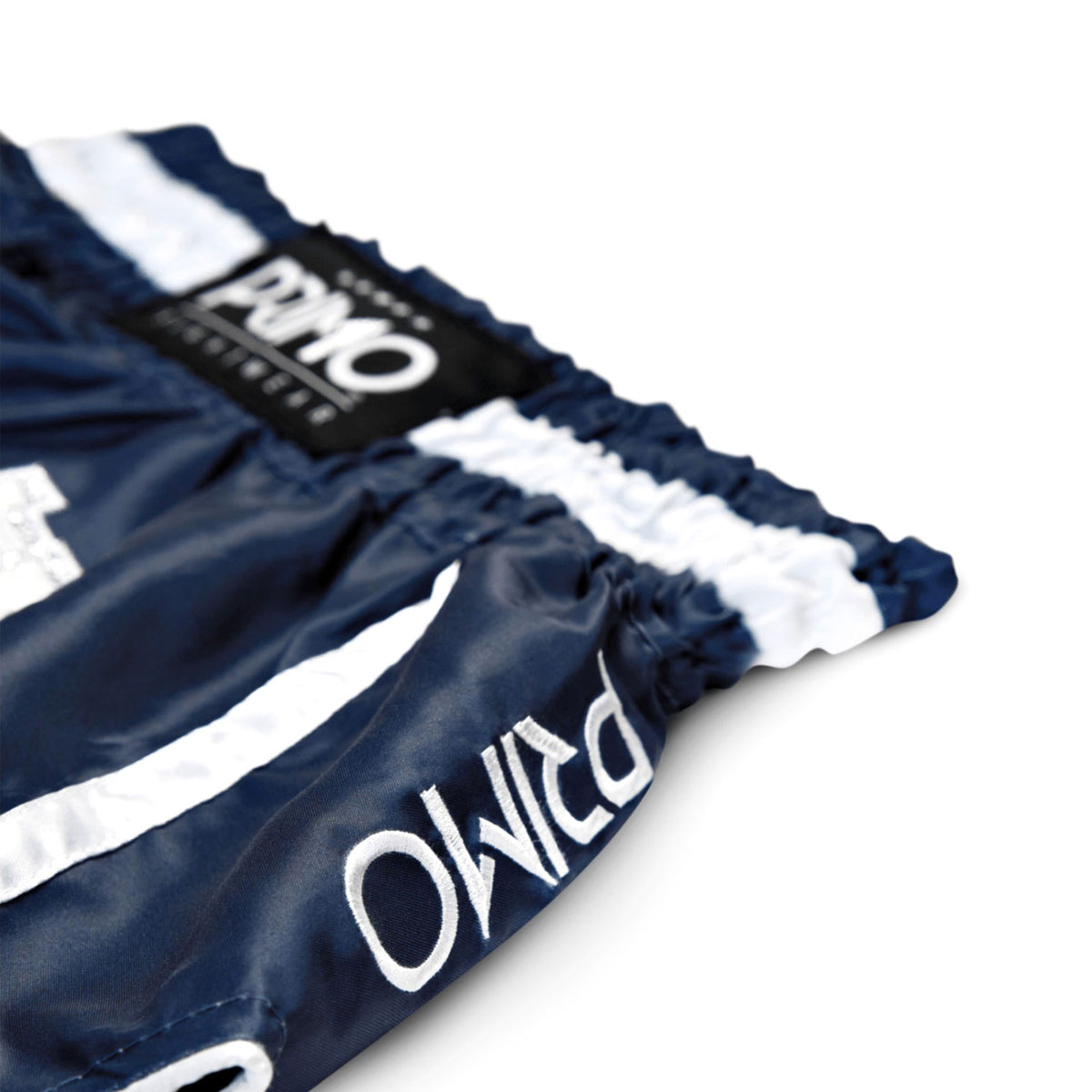 Navy shorts with white stripes and 'DPMO' branding on a white background