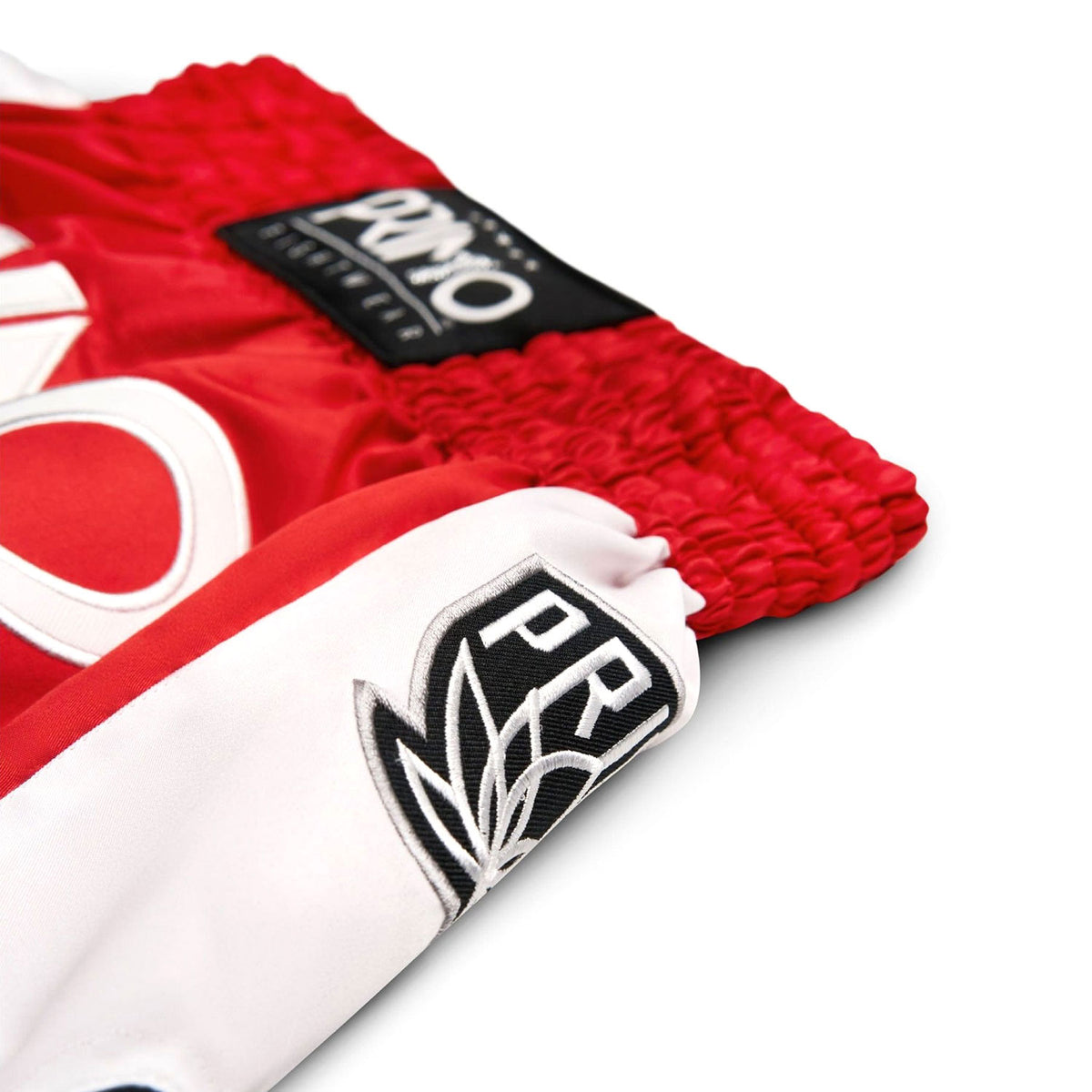 Red and white boxing shorts with 'RIO' branding on a white background