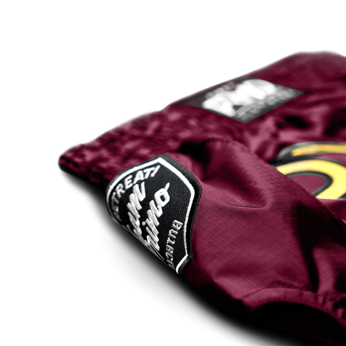 Maroon boxing glove with a brand logo on a white background