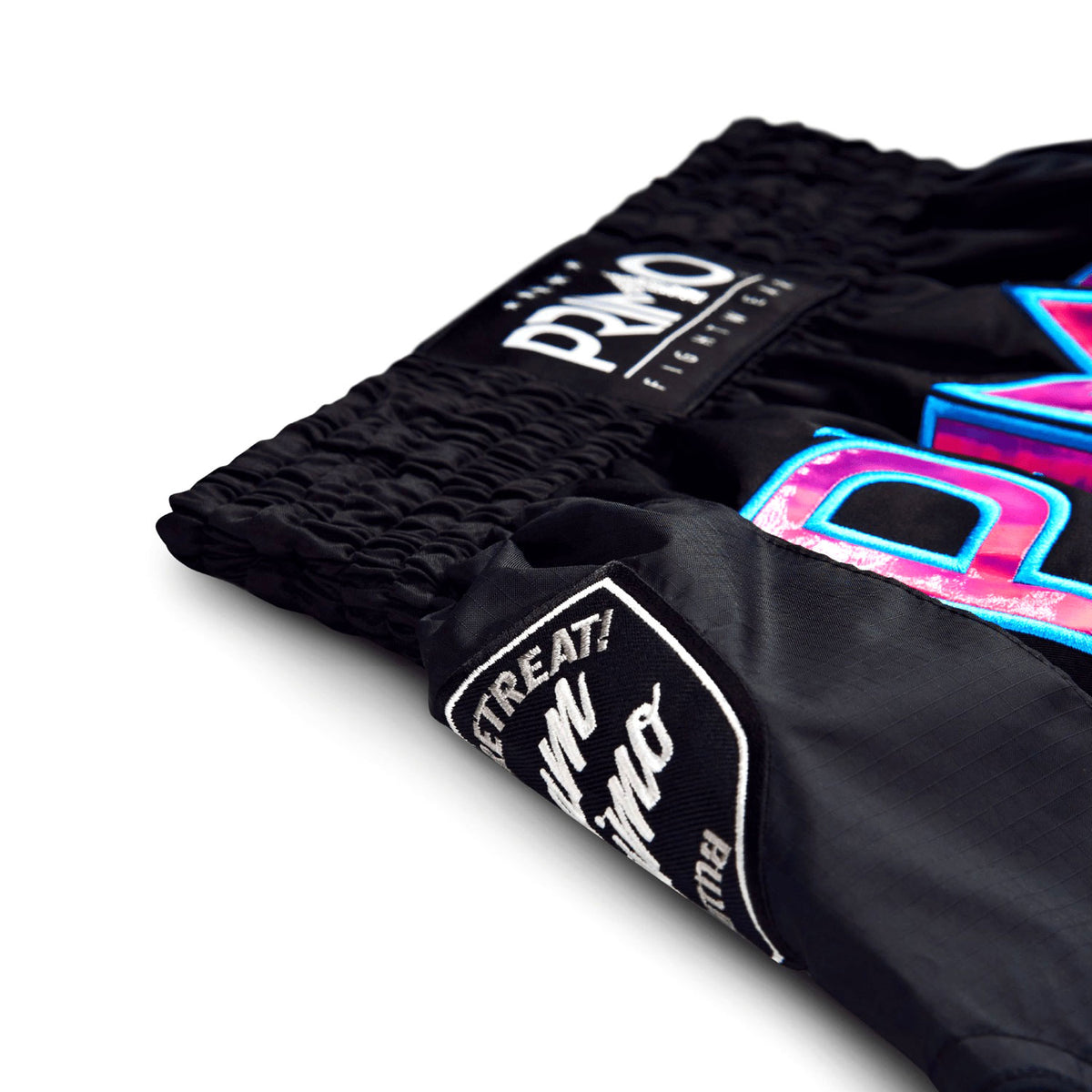 Black boxing shorts with colorful branding on a white background