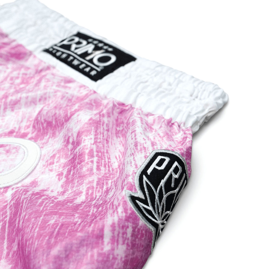 Close-up of a pink and white product with Primo logo on a white background