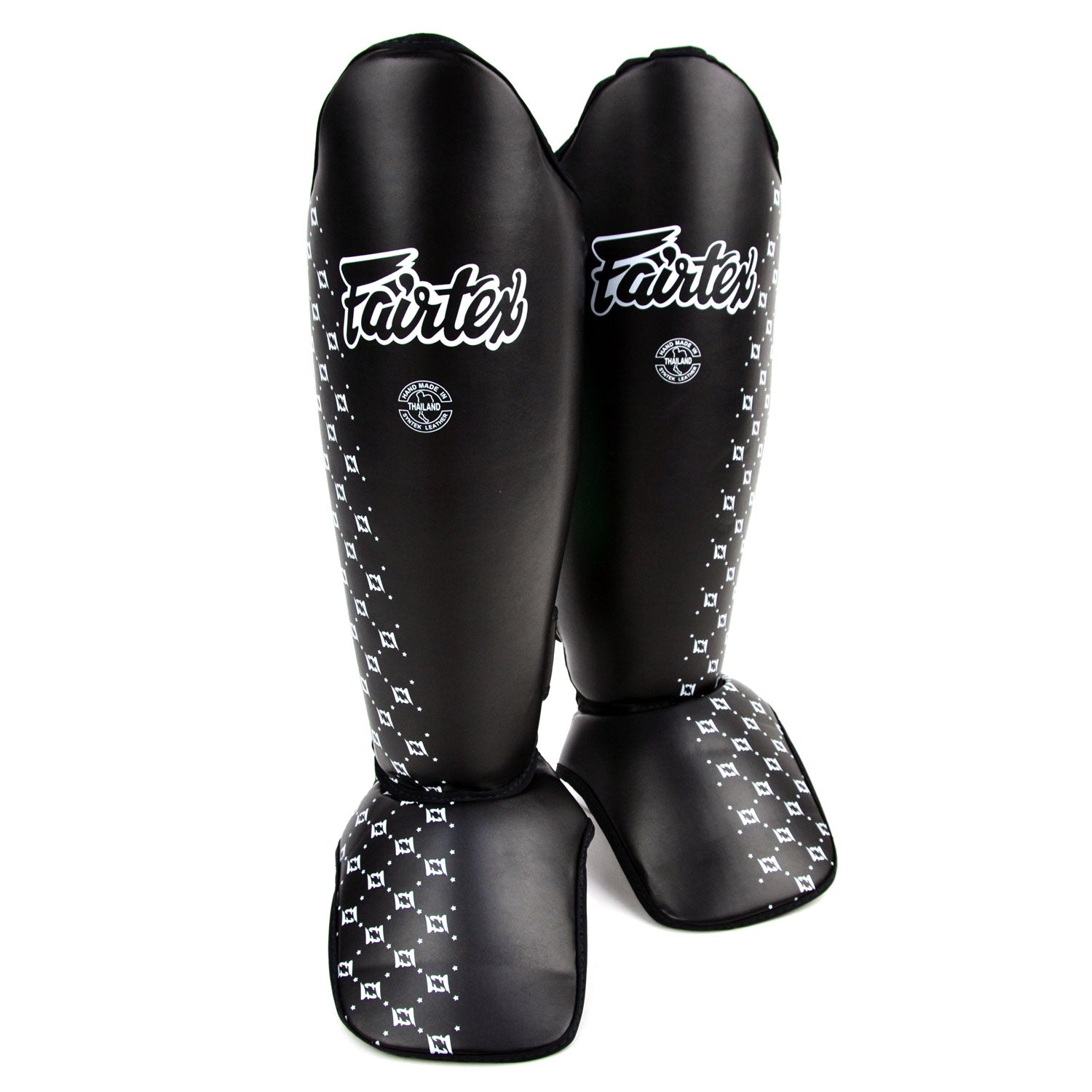 Black shin guards with white pattern and 'Fairtex' branding on a white background