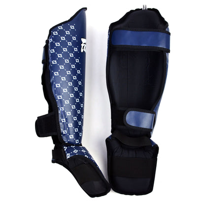 Pair of blue Fairtex shin guards with white patterns on a white background