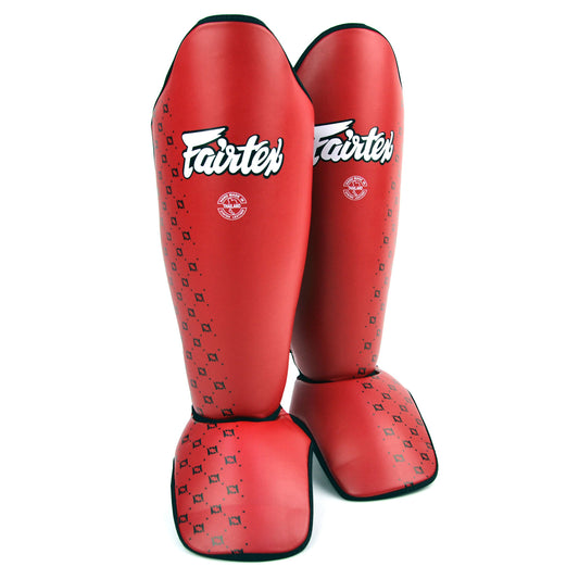 Red shin guards with 'Fairtex' branding on a white background