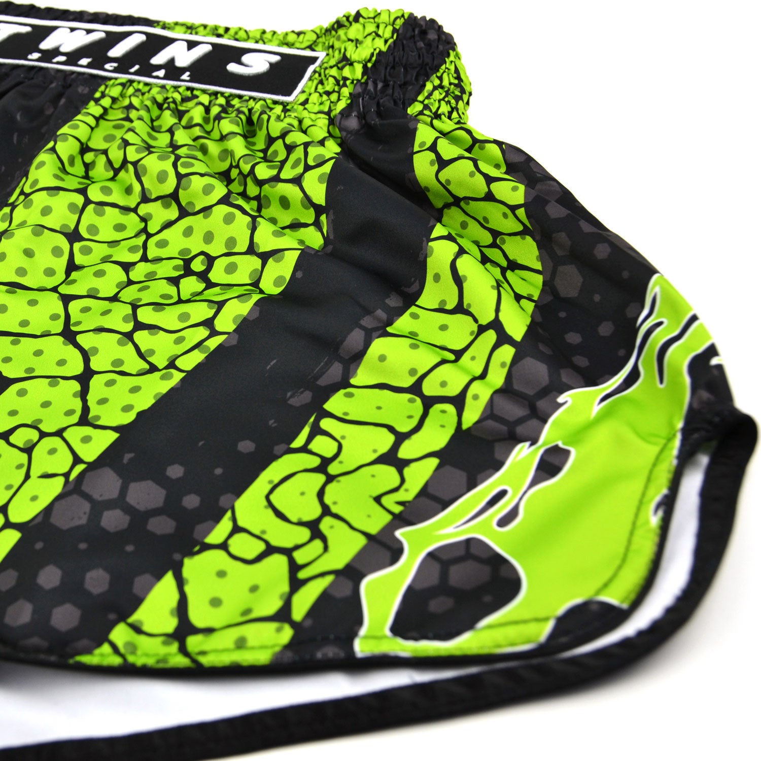 Green and black patterned shorts with 'Twins Special' branding on a white background