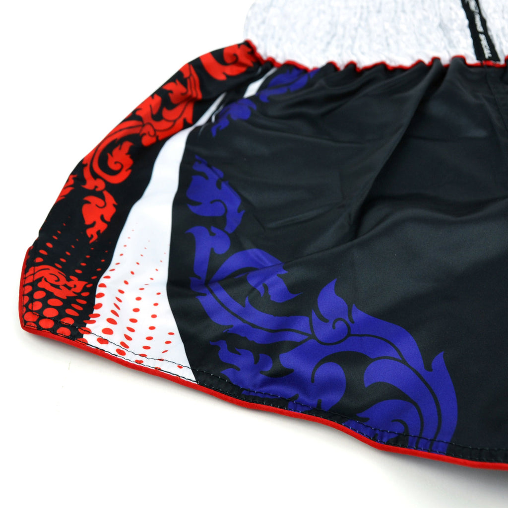 Black boxing shorts with red and blue designs and Twins Special logo on a white background