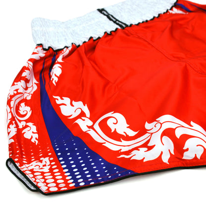 Red boxing shorts with white and blue patterns and 'Twins' branding on a white background