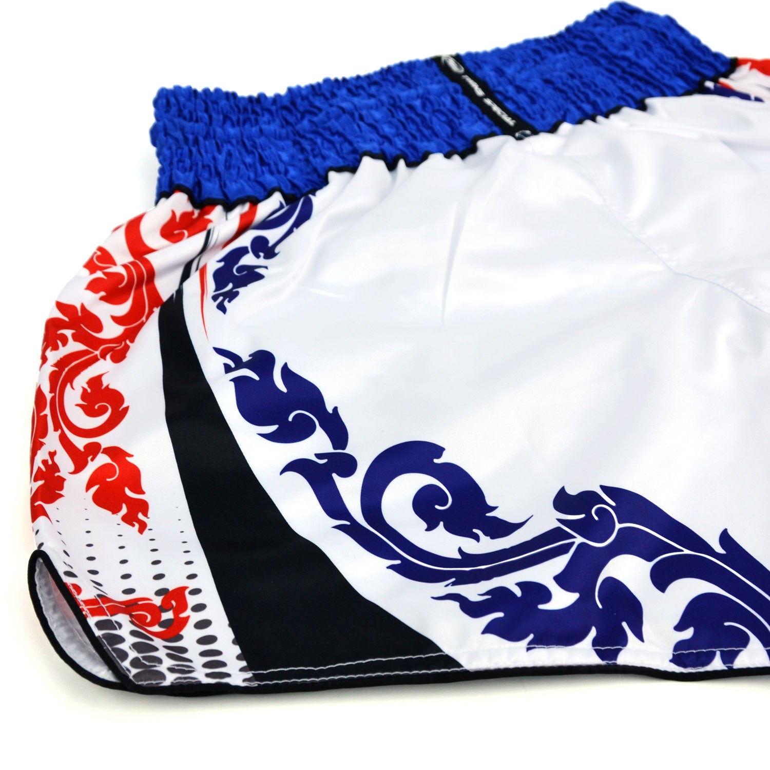 White boxing shorts with blue and red patterns and Twins Special logo on a white background