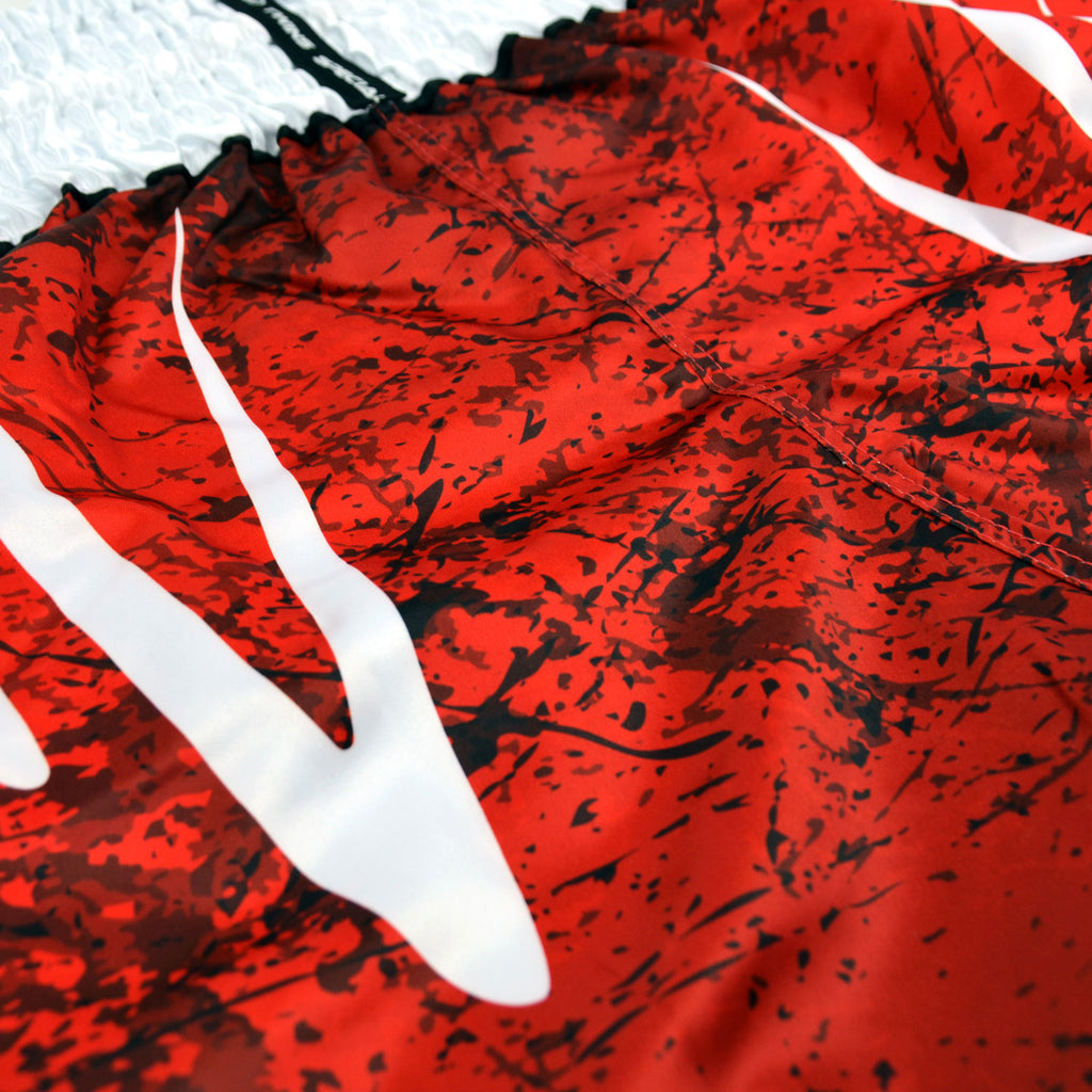 Red and black Twins Special boxing shorts on a white background