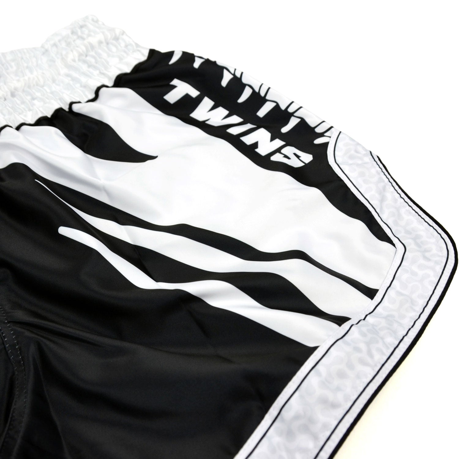 Black and white boxing shorts with 'Twins Special' branding on a white background